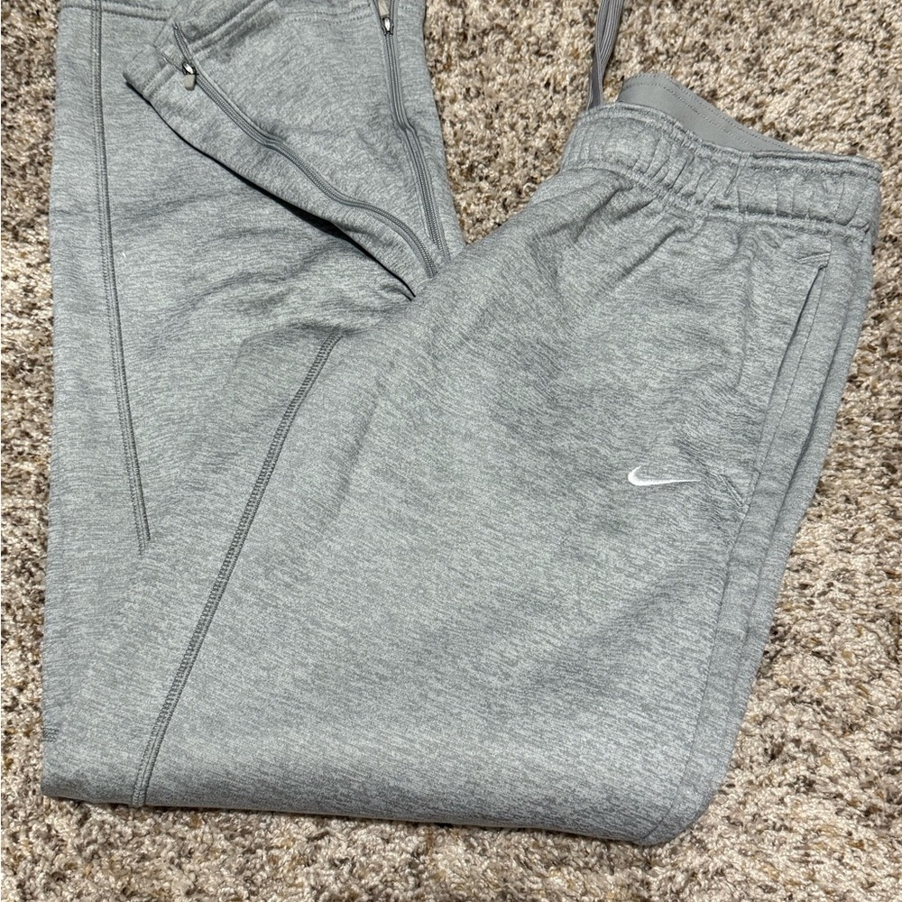 Nike straight leg sweatpants with zippered bottoms. Size M women’s